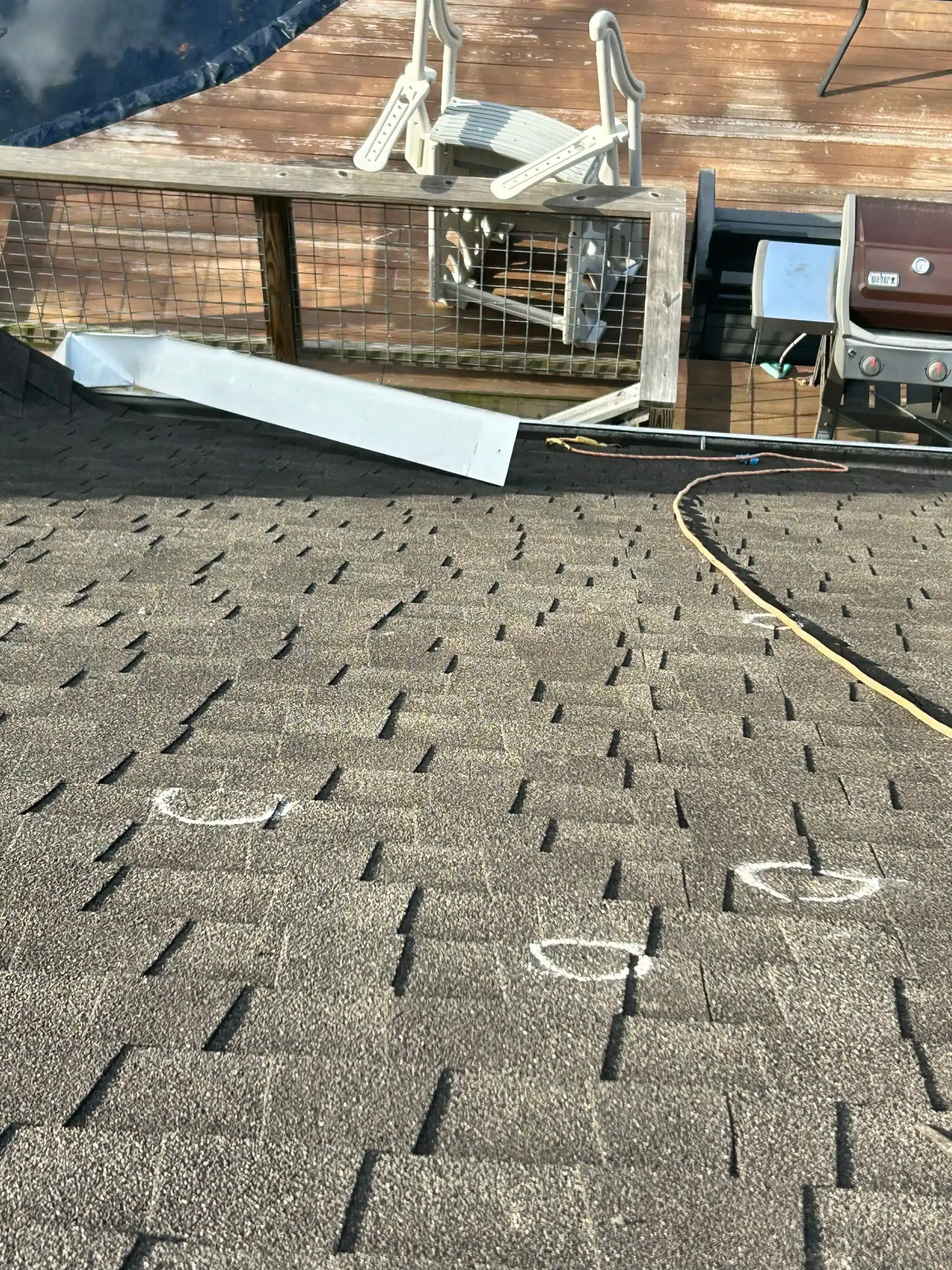 Hail impact marks documented on asphalt shingles during a roof inspection in Sandy Springs