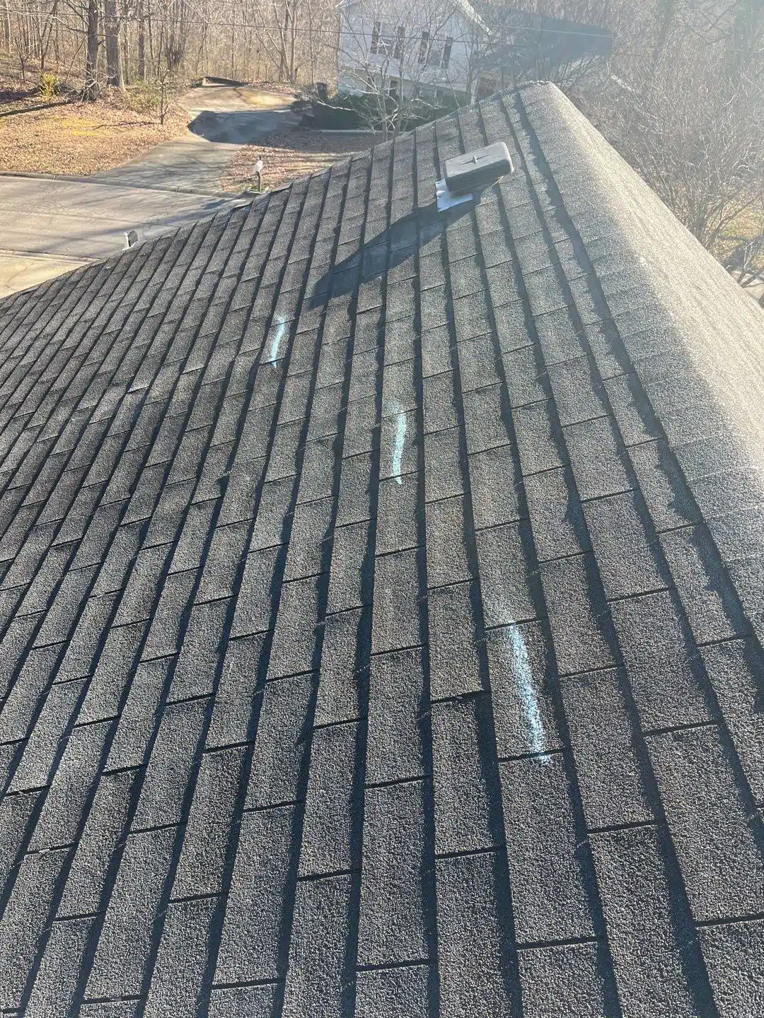 Wind-damaged shingles documented during a roof inspection in Roswell, GA