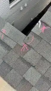 Close-up of an asphalt shingle repair area with sealant marks, documented by Inspector Roofing