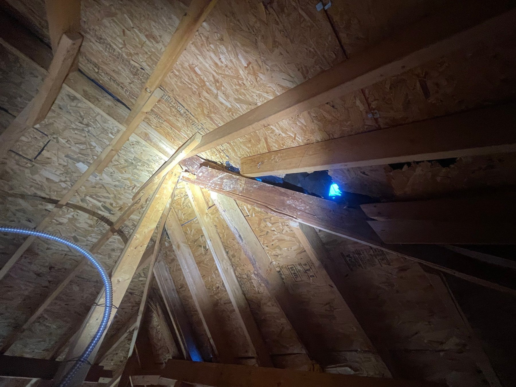 Sunlight through a roof deck, photographed from the attic